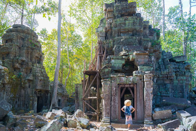 Rear view of people outside temple against building