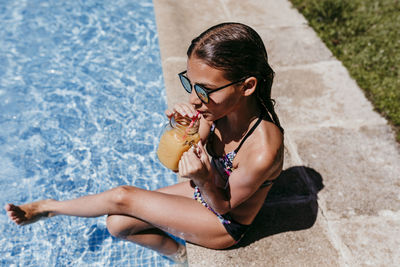 Young woman enjoying in swimming pool
