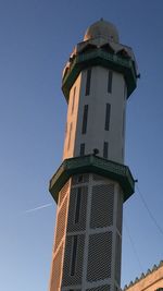 Low angle view of lighthouse against clear blue sky