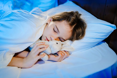 Young woman sleeping on bed