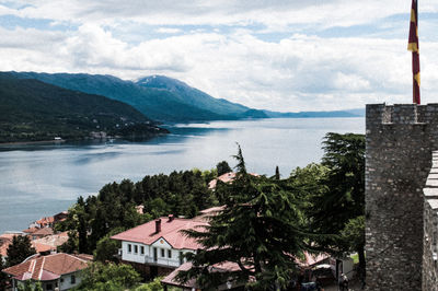 Scenic view of lake by buildings against sky