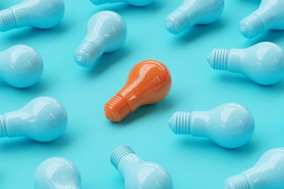 High angle view of light bulbs against blue background