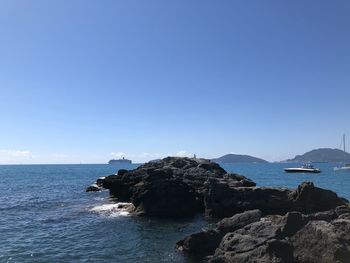 Scenic view of sea against clear blue sky