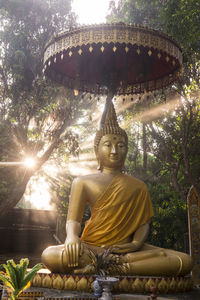 Low angle view of statue against temple