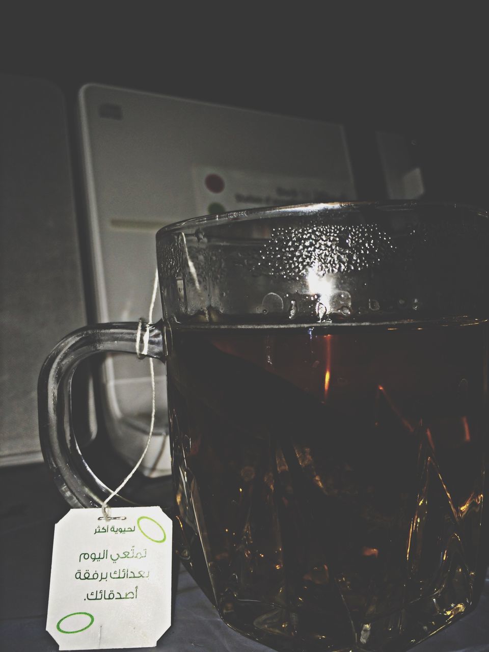 indoors, close-up, technology, communication, still life, no people, table, glass - material, text, focus on foreground, western script, reflection, metal, illuminated, transparent, old-fashioned, high angle view, drink, connection, retro styled