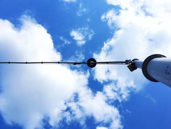 Directly below shot of street light against blue sky