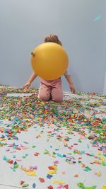 Low angle view of multi colored candies on wall