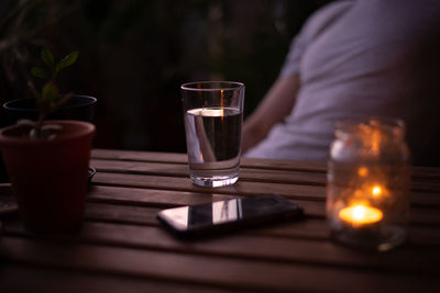 Midsection of woman using mobile phone on table