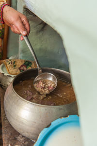 Cropped hand of person preparing food