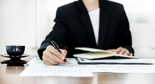 Midsection of businessman working at office