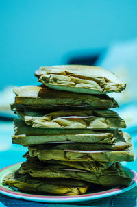 Close-up of stack on table against blue background