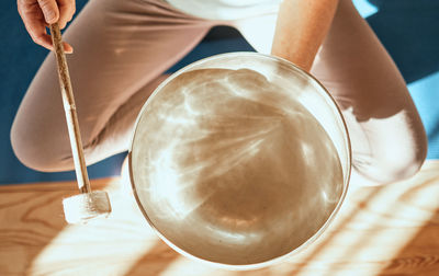 Midsection of woman holding light bulb