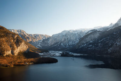 Scenic view of lake and mountains against clear sky