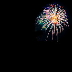Low angle view of firework display at night
