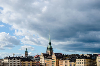 Buildings against cloudy sky