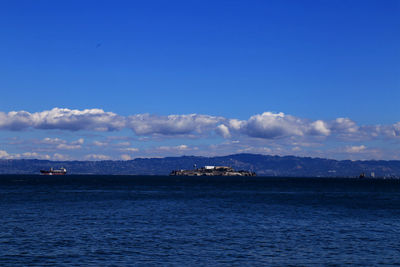Scenic view of sea against blue sky