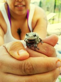 Midsection of woman holding frog