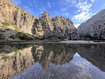 Scenic view of lake and mountains against sky