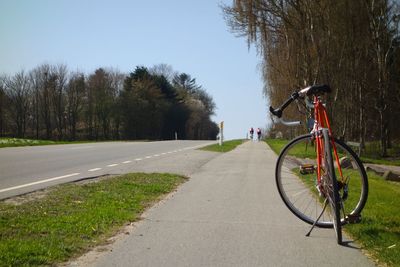 Bicycle on road against clear sky