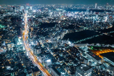 High angle view of city lit up at night