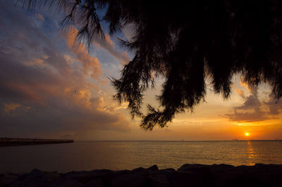 Scenic view of sea against orange sky