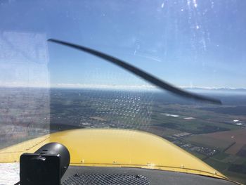 Close-up of airplane wing against sky