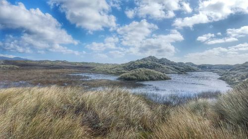 Scenic view of landscape against cloudy sky