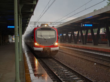Train at railroad station platform during rainy season