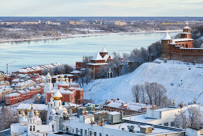 High angle view of townscape by river during winter