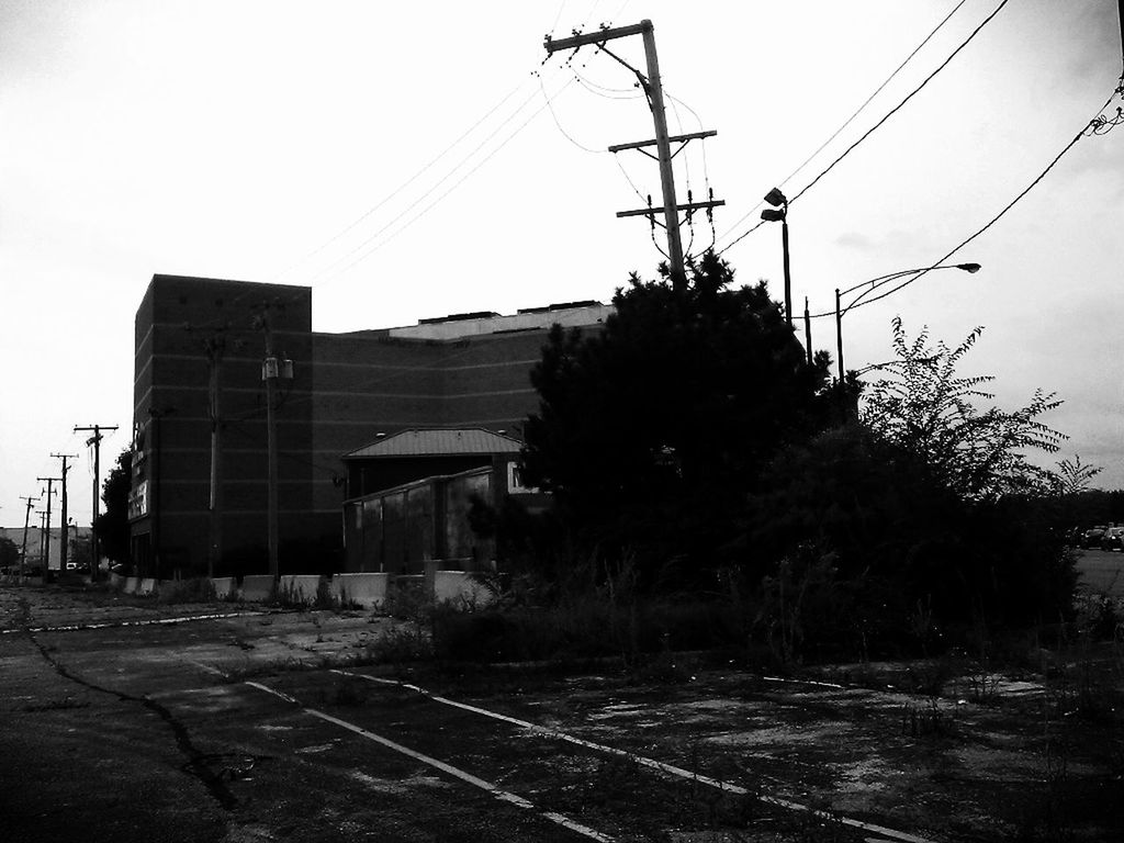 power line, electricity pylon, clear sky, cable, electricity, power supply, built structure, building exterior, architecture, railroad track, fuel and power generation, transportation, house, connection, sky, rail transportation, tree, power cable, outdoors, road