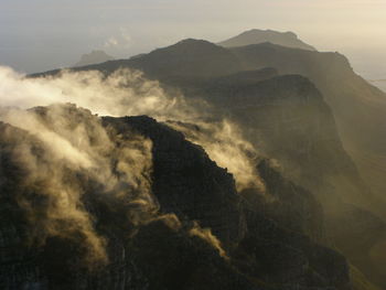 Scenic view of mountains against cloudy sky