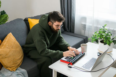 Young man using laptop at home