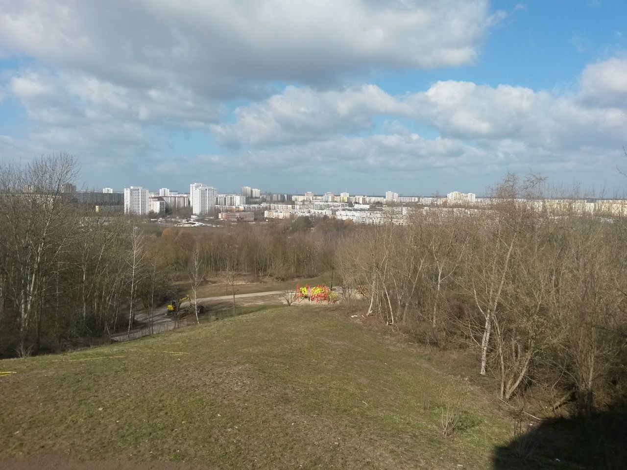 ROAD AMIDST BUILDINGS AGAINST SKY