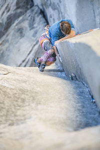 Athlete rock climbing the crux pitch of the nose on el capitan