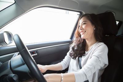 Young woman sitting in car