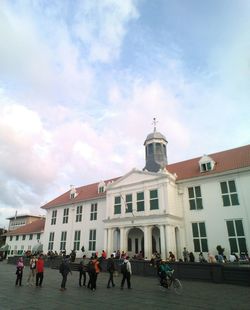 People walking in front of building