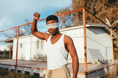 Man standing by railing against built structure