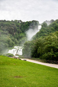 Scenic view of waterfall against sky