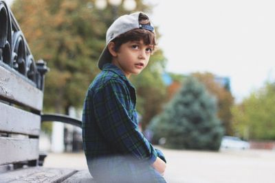 Side view of boy looking away outdoors