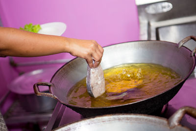 Midsection of woman preparing food in kitchen