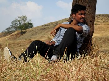 High angle view of a young woman in grass