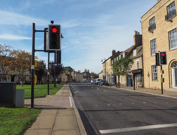 Road signs in city against sky