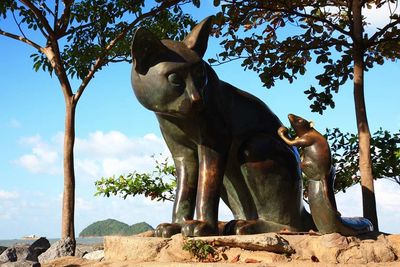 Low angle view of horse statue against trees