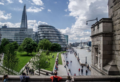 High angle view of people walking by city hall and shard london bridge in city