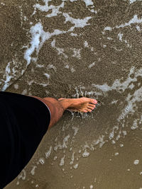 Low section of person on sand