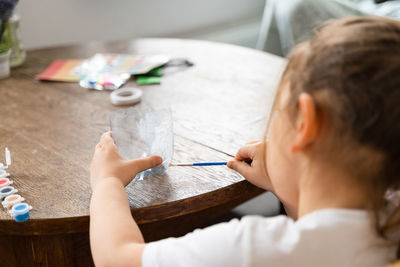 Close-up of boy drawing on table