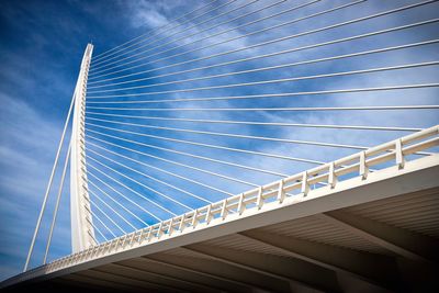 Low angle view of suspension bridge against sky