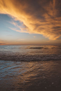 Scenic view of beach against sky during sunset