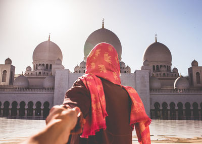 Tourists at temple against building