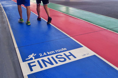 Low section of athletes running on sports track